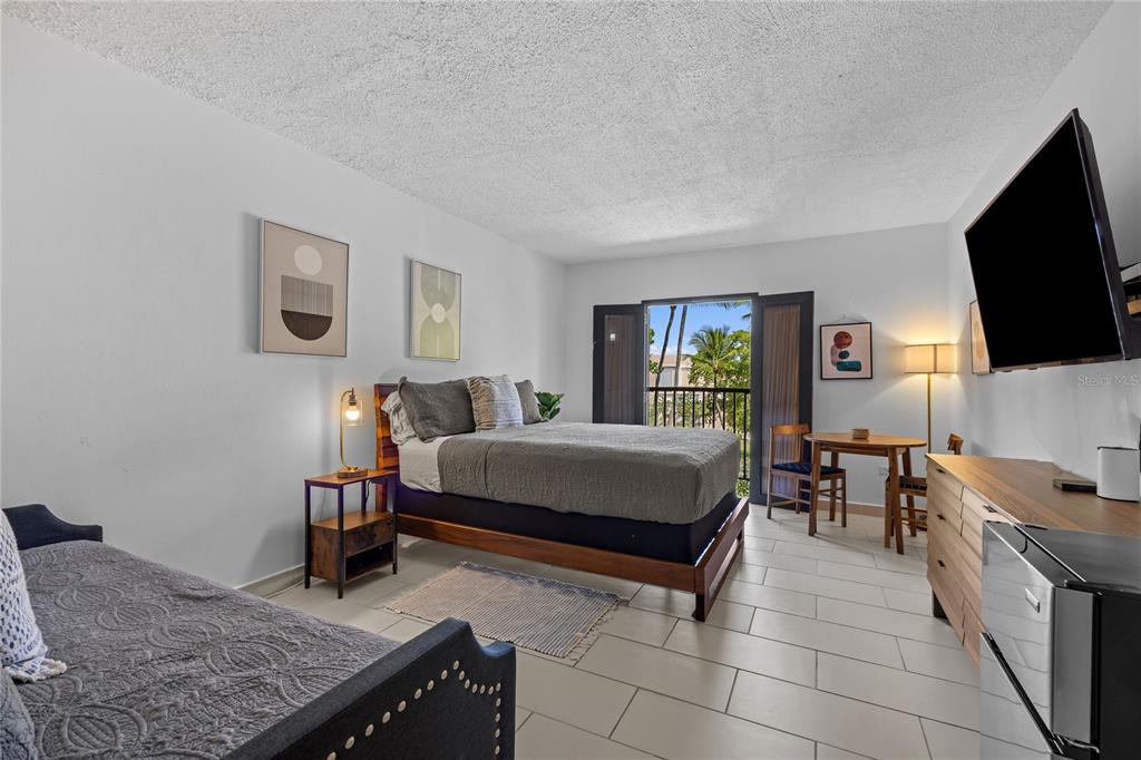 2066 Montesol, Unit 2066 Humacao, PR 00792 - Photo 20 of 29 a bedroom with a bed and flat screen tv