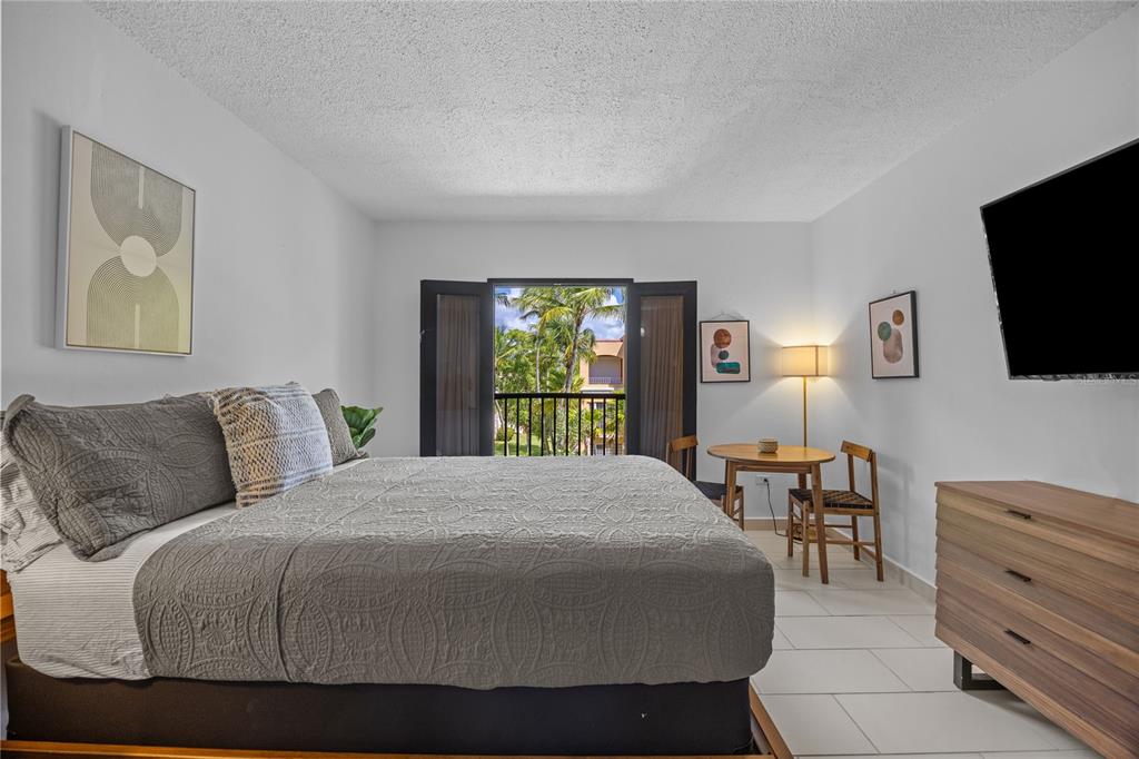 2066 Montesol, Unit 2066 Humacao, PR 00792 - Photo 21 of 29 a bedroom with a bed and a flat screen tv