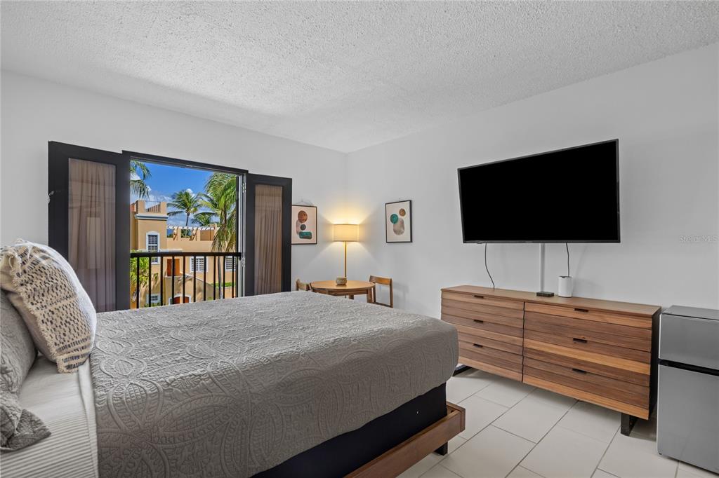 2066 Montesol, Unit 2066 Humacao, PR 00792 - Photo 22 of 29 a bedroom with a bed and a flat screen tv