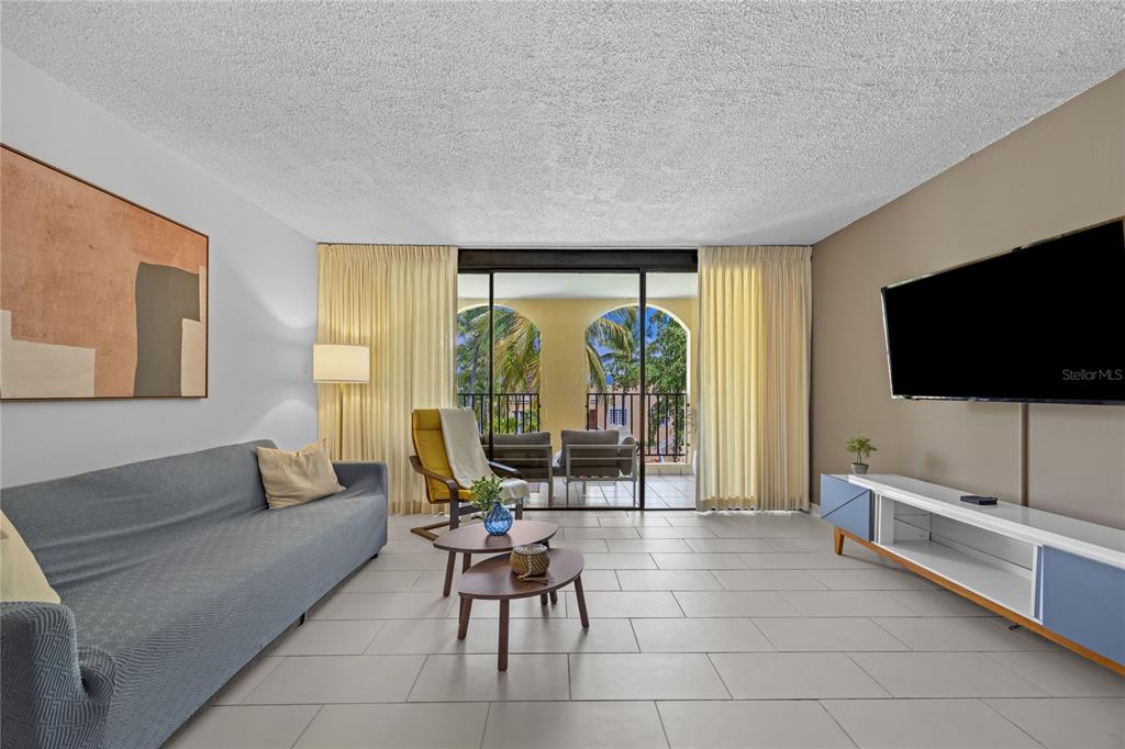 2066 Montesol, Unit 2066 Humacao, PR 00792 - Photo 6 of 29 a living room with furniture and a flat screen tv
