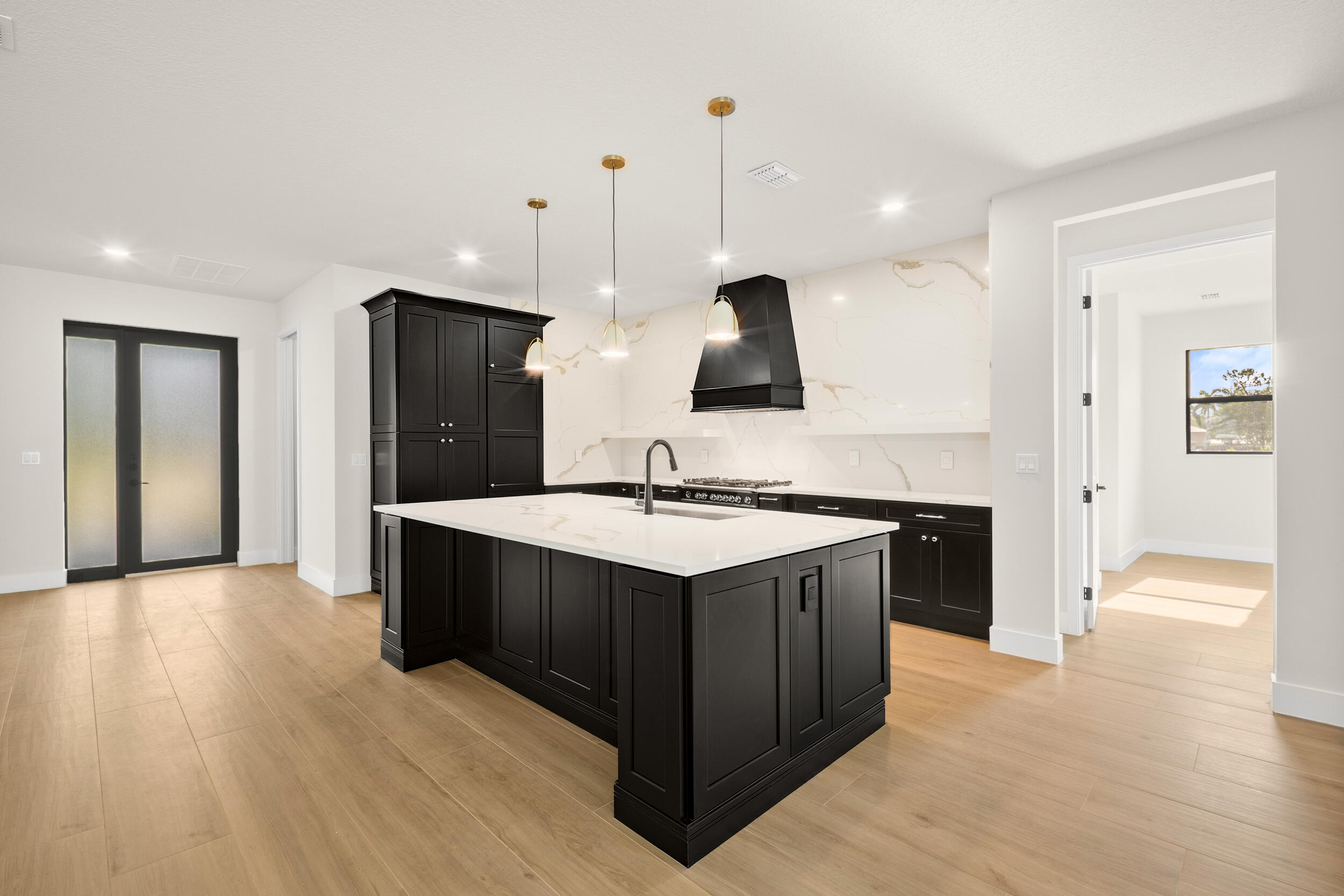 1142 Southwest Abbey Avenue Port St. Lucie, FL 34953 - Photo 12 of 57 a kitchen with stainless steel appliances granite countertop a sink and a stove