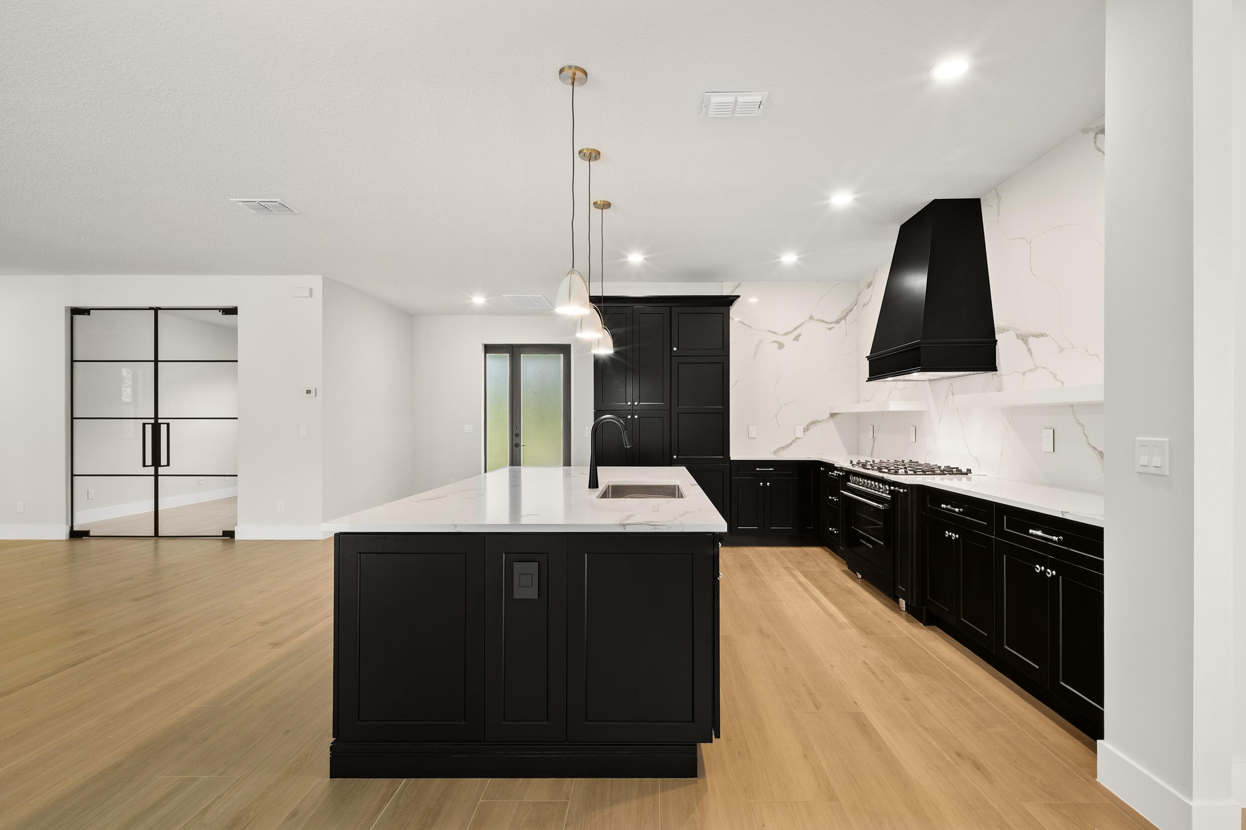 1142 Southwest Abbey Avenue Port St. Lucie, FL 34953 - Photo 15 of 57 a kitchen with kitchen island granite countertop a sink a counter top space and cabinets