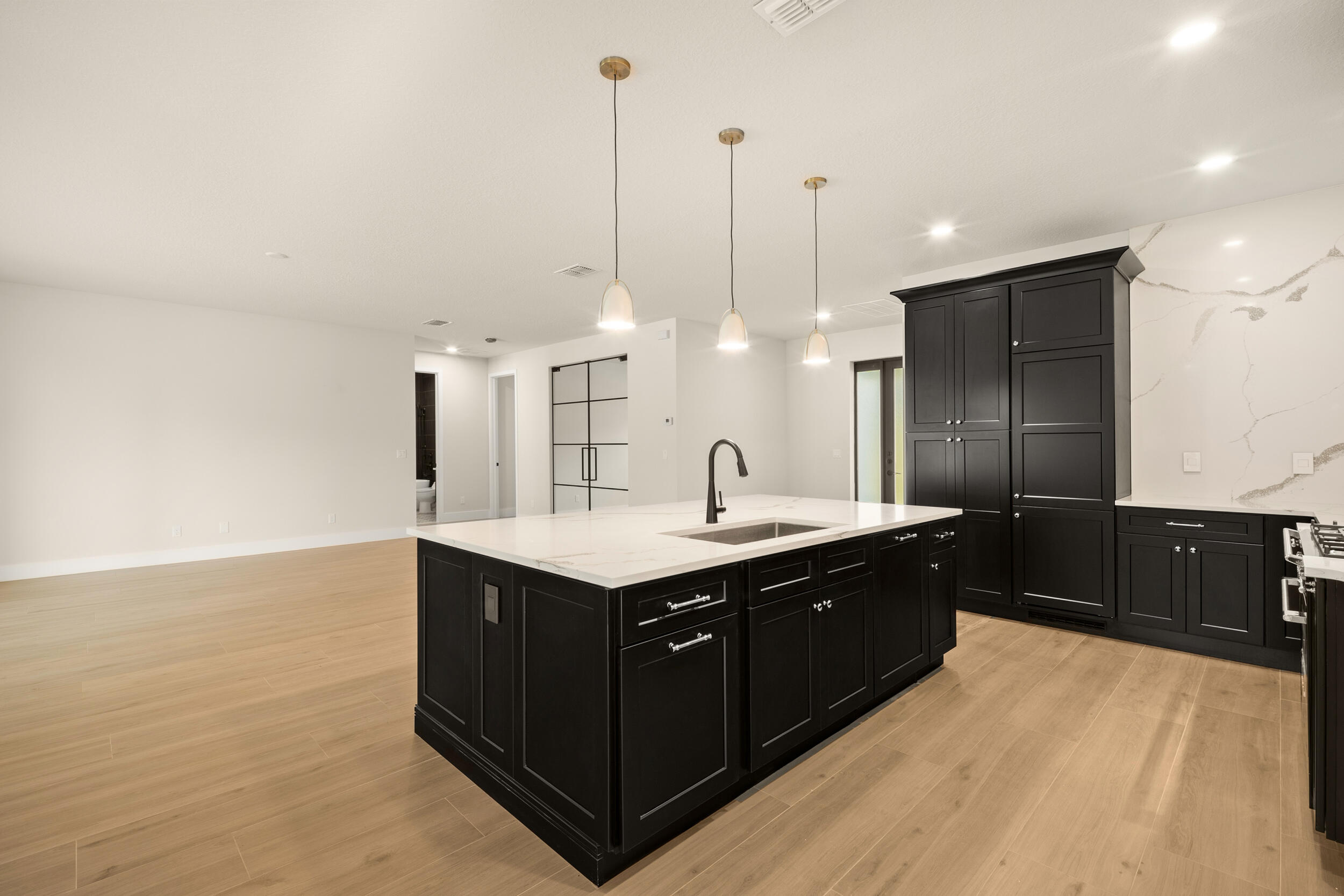 1142 Southwest Abbey Avenue Port St. Lucie, FL 34953 - Photo 16 of 57 a kitchen with stainless steel appliances granite countertop a sink a counter space and cabinets