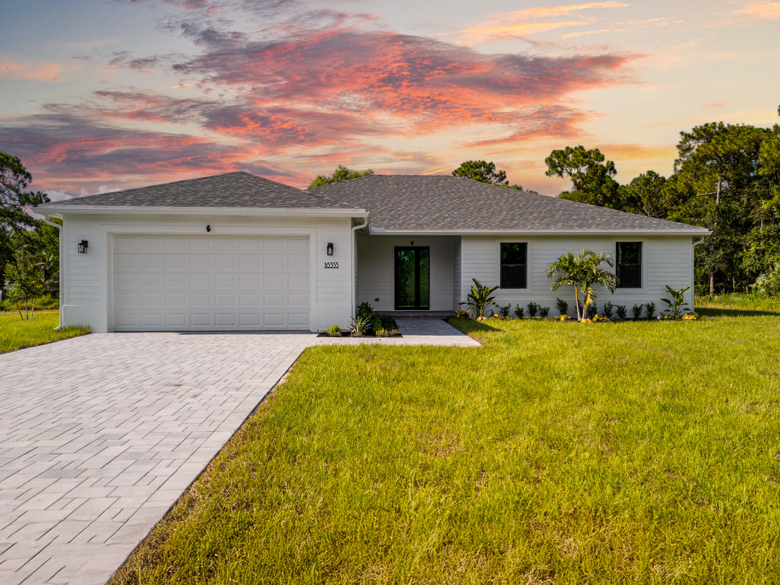 1142 Southwest Abbey Avenue Port St. Lucie, FL 34953 - Photo 2 of 57 a front view of house with yard and outdoor seating