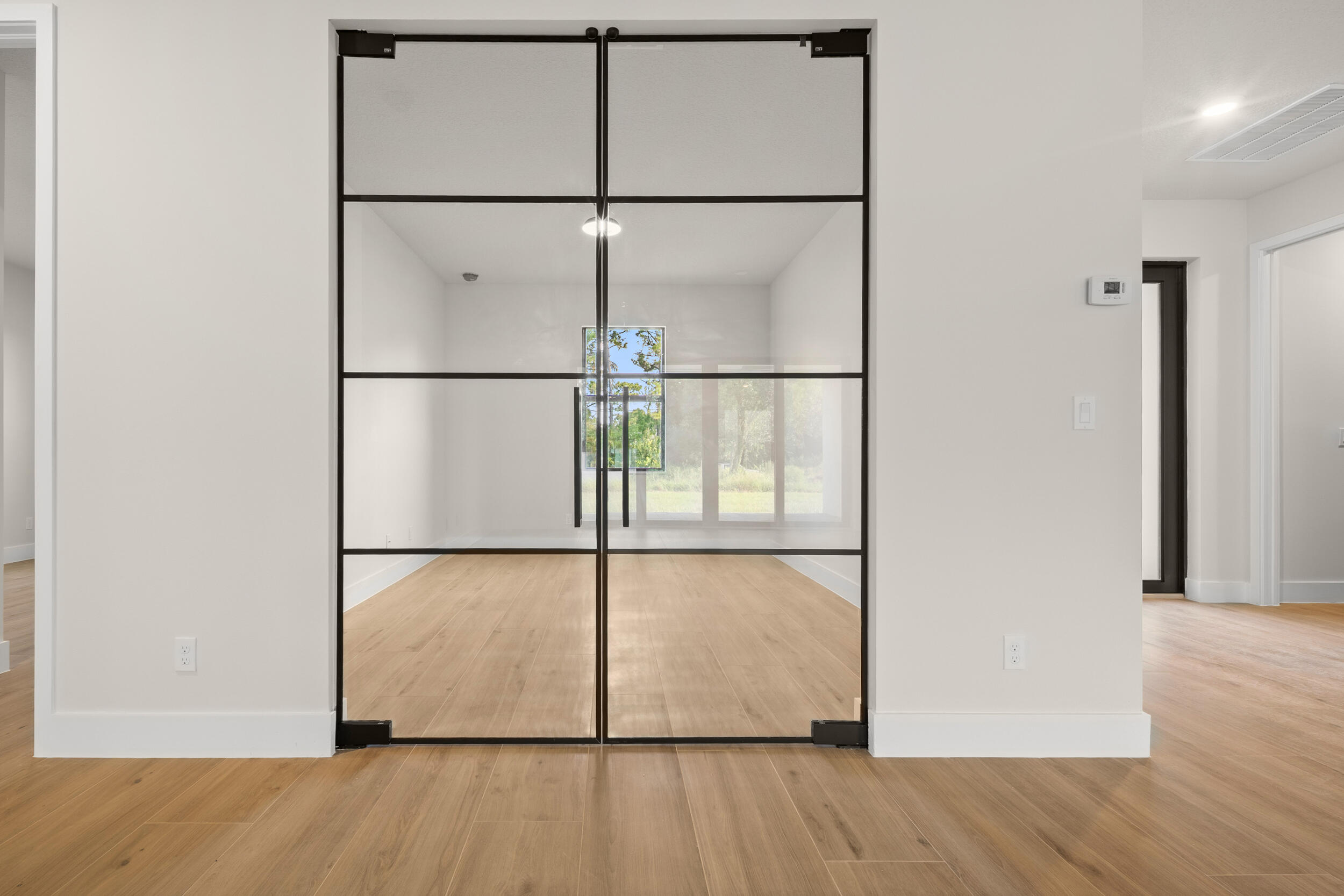 1142 Southwest Abbey Avenue Port St. Lucie, FL 34953 - Photo 23 of 57 a view of an empty room with wooden floor