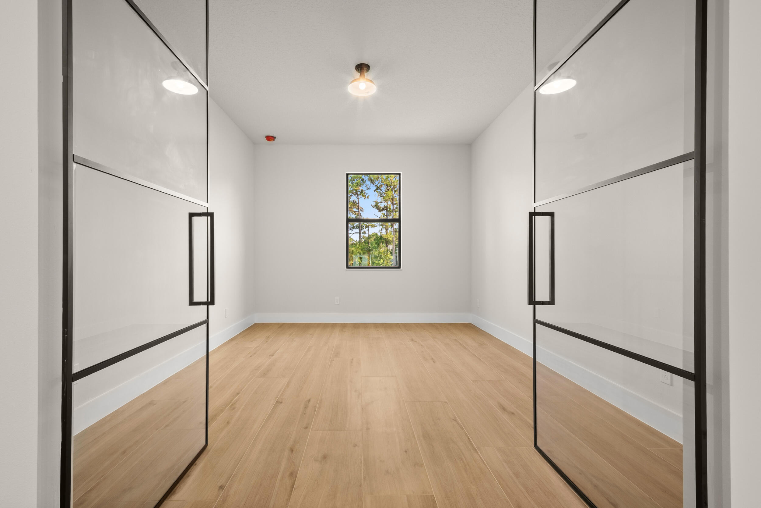 1142 Southwest Abbey Avenue Port St. Lucie, FL 34953 - Photo 24 of 57 a view of empty room with wooden floor and window