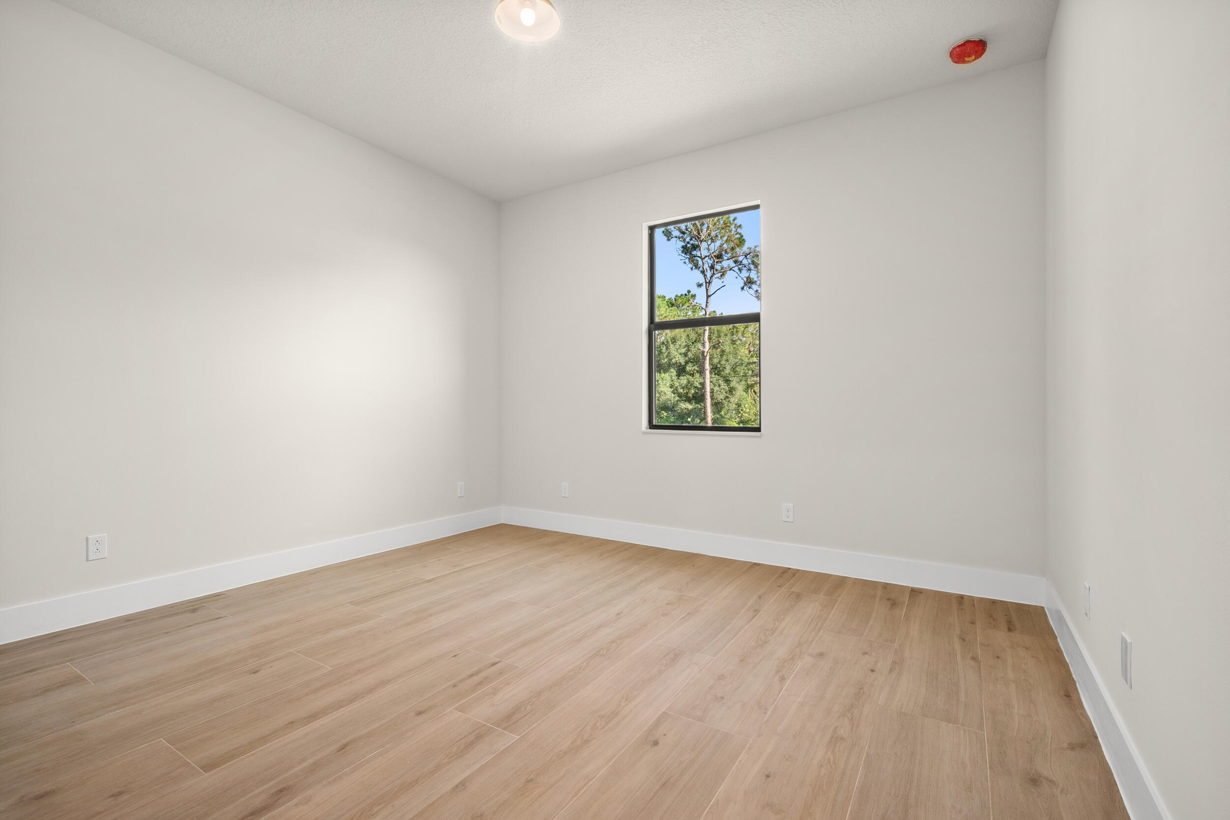 1142 Southwest Abbey Avenue Port St. Lucie, FL 34953 - Photo 30 of 57 an empty room with a painting on the wall