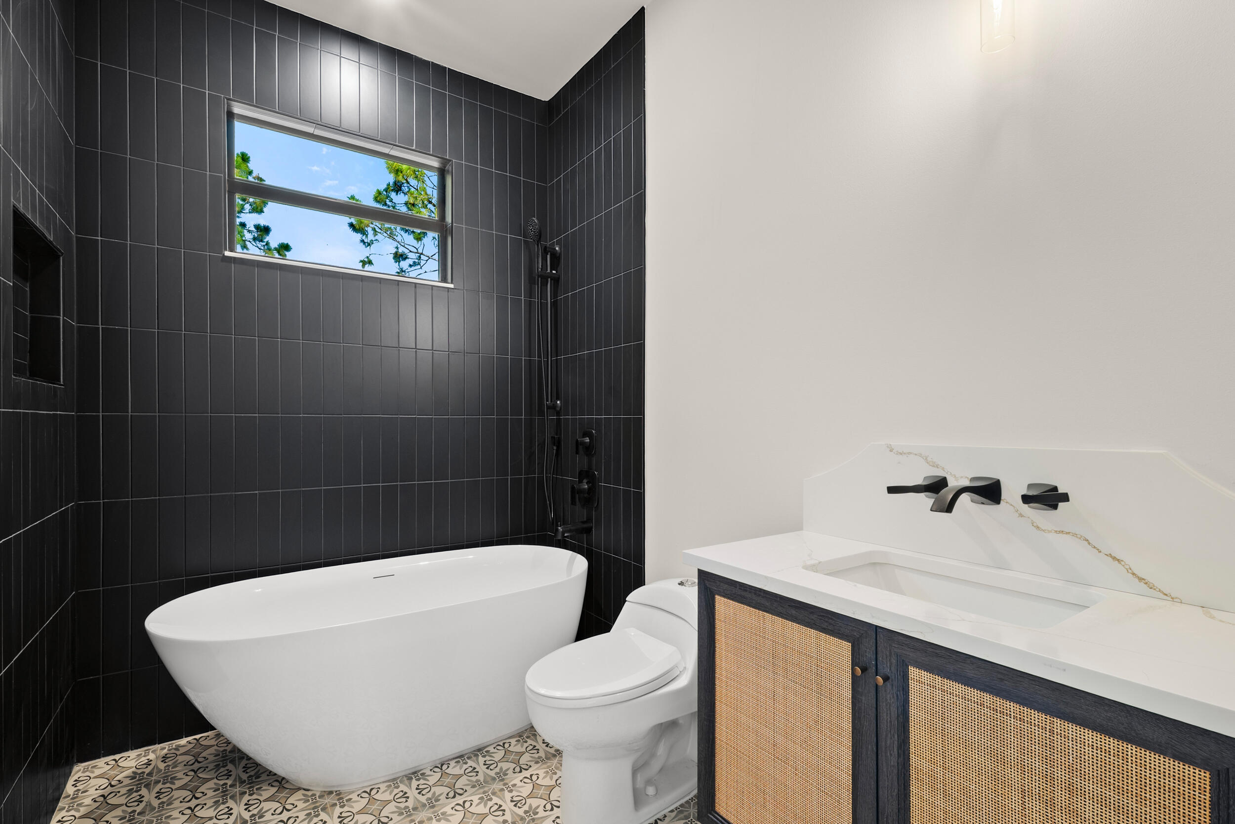 1142 Southwest Abbey Avenue Port St. Lucie, FL 34953 - Photo 33 of 57 a white toilet sitting next to a bathroom sink and tub