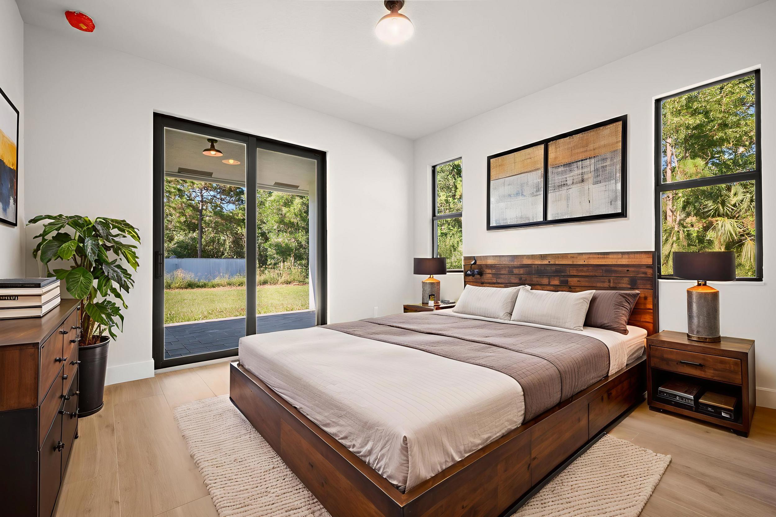 1142 Southwest Abbey Avenue Port St. Lucie, FL 34953 - Photo 55 of 57 a bedroom with a large bed and a large window with balcony view