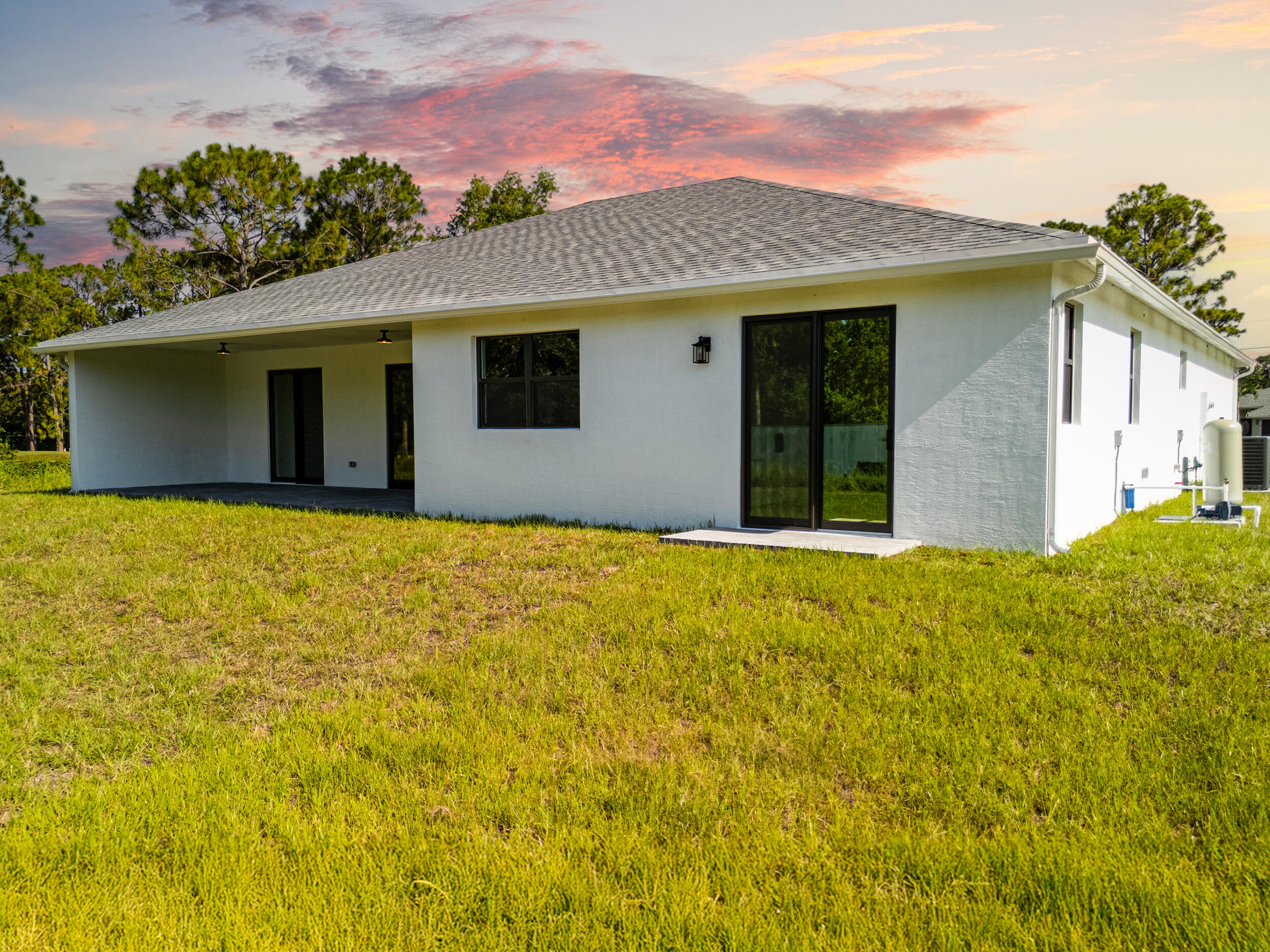 1142 Southwest Abbey Avenue Port St. Lucie, FL 34953 - Photo 6 of 57 a house with swimming pool in front of it