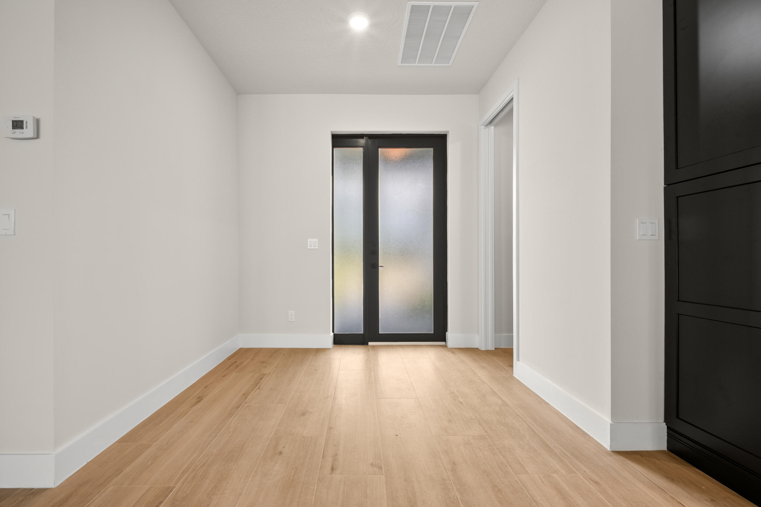 1142 Southwest Abbey Avenue Port St. Lucie, FL 34953 - Photo 7 of 57 a view of wooden floor in an empty room