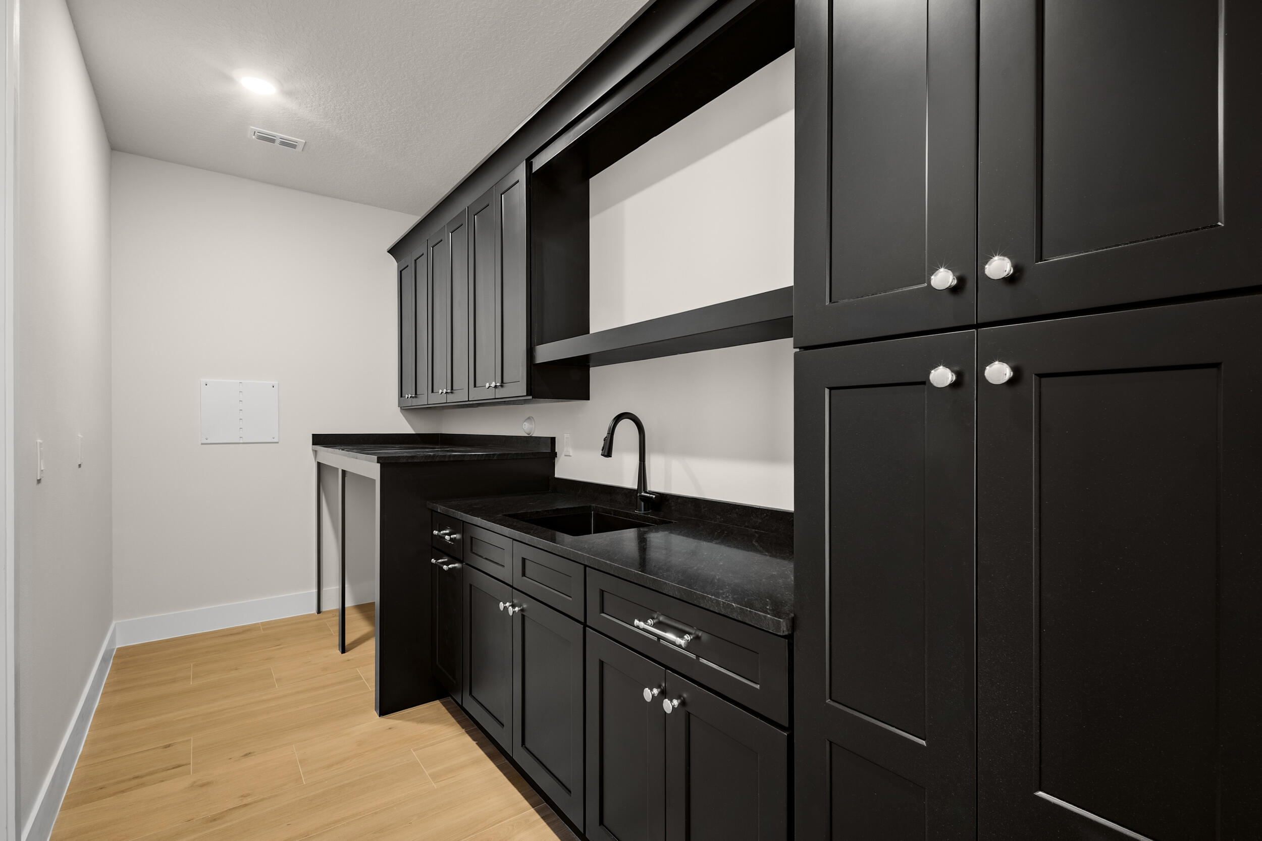 1142 Southwest Abbey Avenue Port St. Lucie, FL 34953 - Photo 8 of 57 a kitchen with granite countertop a sink and cabinets