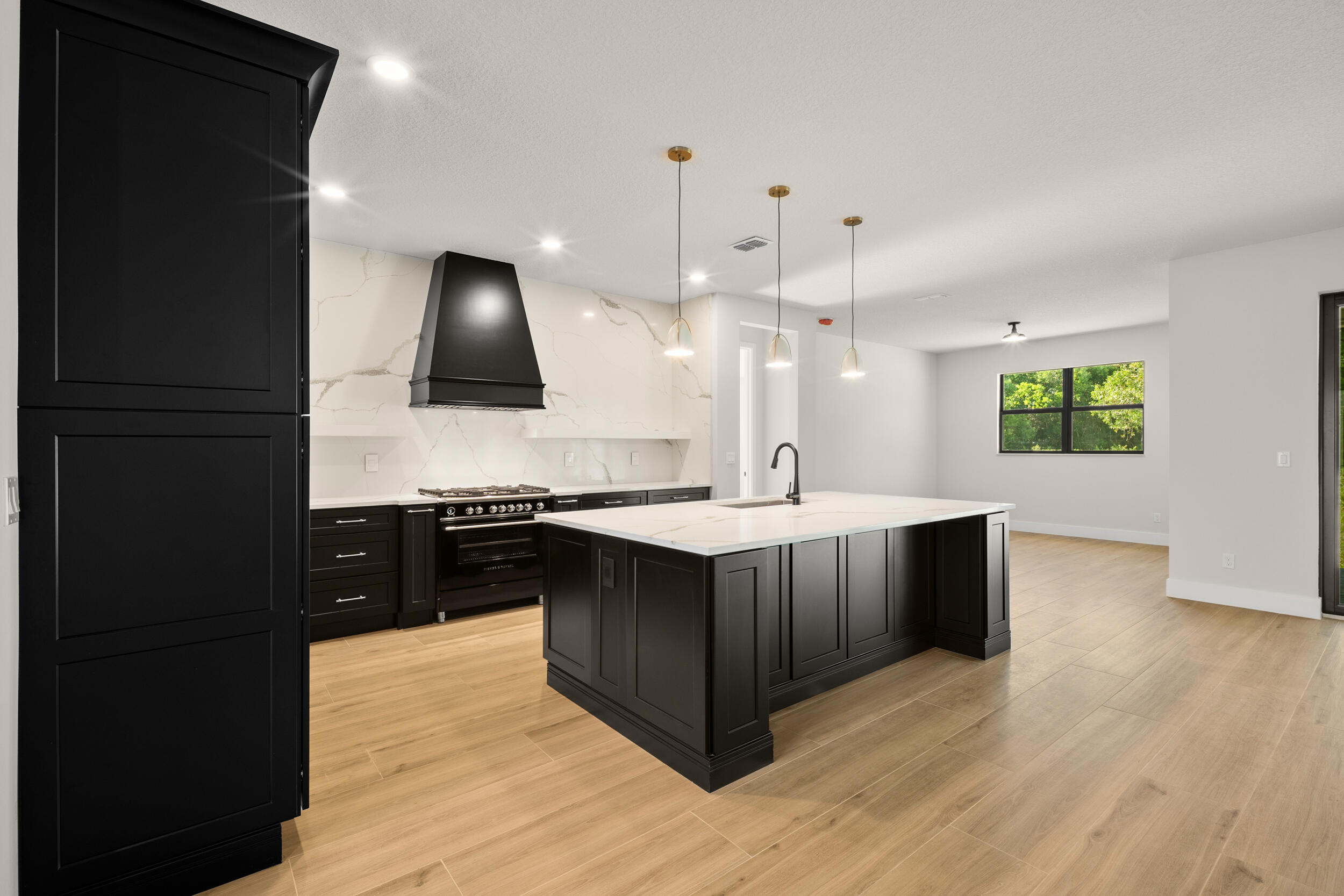 1142 Southwest Abbey Avenue Port St. Lucie, FL 34953 - Photo 10 of 57 a kitchen with stainless steel appliances granite countertop wooden cabinets a stove a sink and a wooden floors