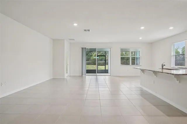 a kitchen with stainless steel appliances granite countertop a stove a sink and a white cabinets