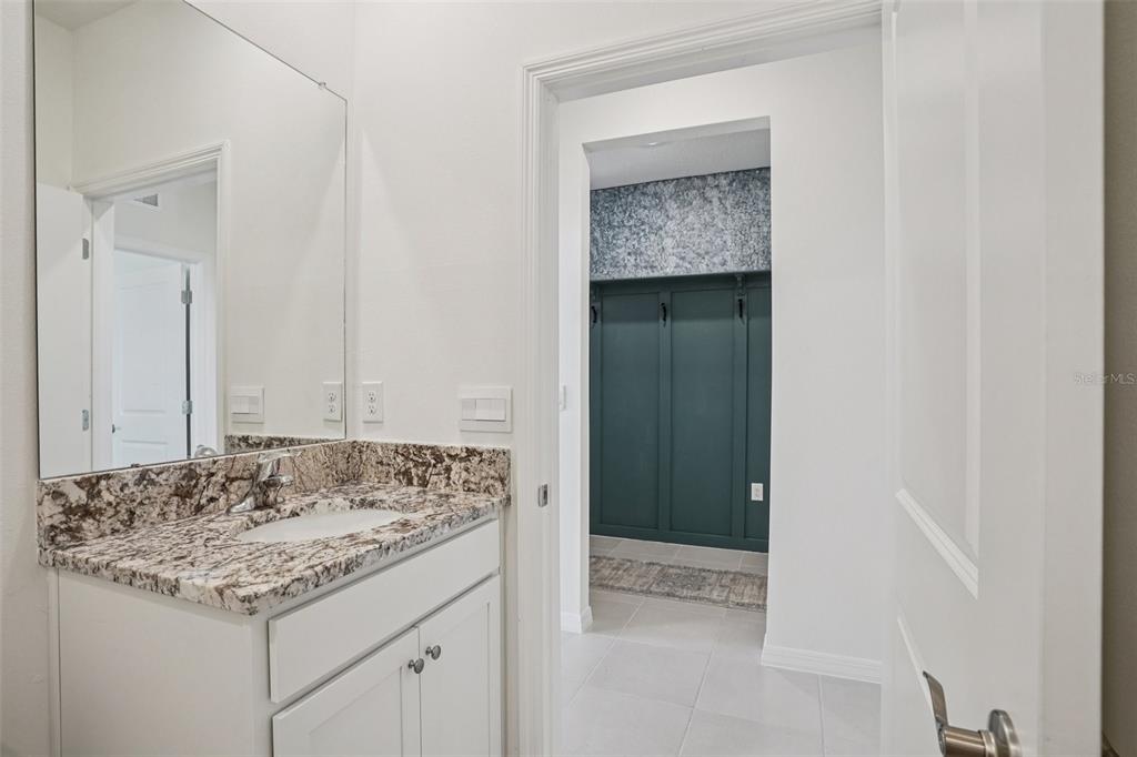 6203 Southwest 93rd Loop Ocala, FL 34476 - Photo 18 of 54 a bathroom with a granite countertop sink and a mirror