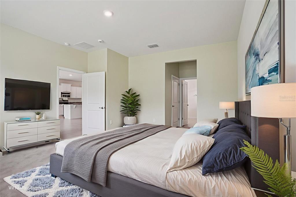 6203 Southwest 93rd Loop Ocala, FL 34476 - Photo 19 of 54 a bedroom with a bed and a flat screen tv