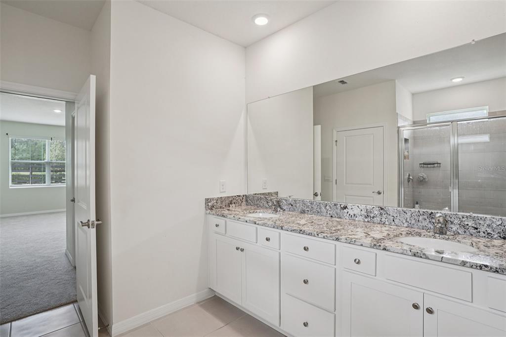 6203 Southwest 93rd Loop Ocala, FL 34476 - Photo 24 of 54 a bathroom with a granite countertop sink and a mirror