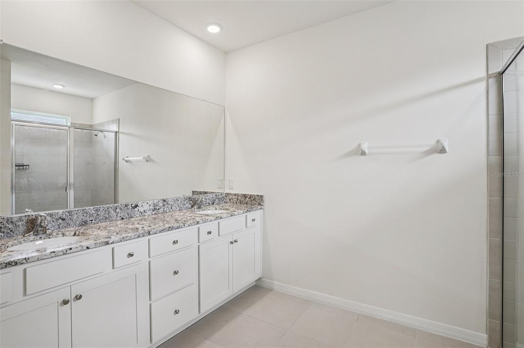 6203 Southwest 93rd Loop Ocala, FL 34476 - Photo 25 of 54 a bathroom with a granite countertop sink and mirror
