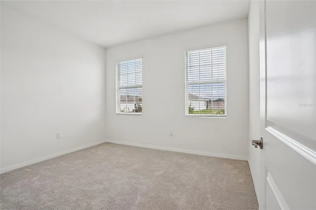 a view of an empty room and a window