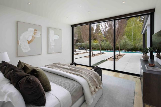 a bed sitting in a bedroom next to a window