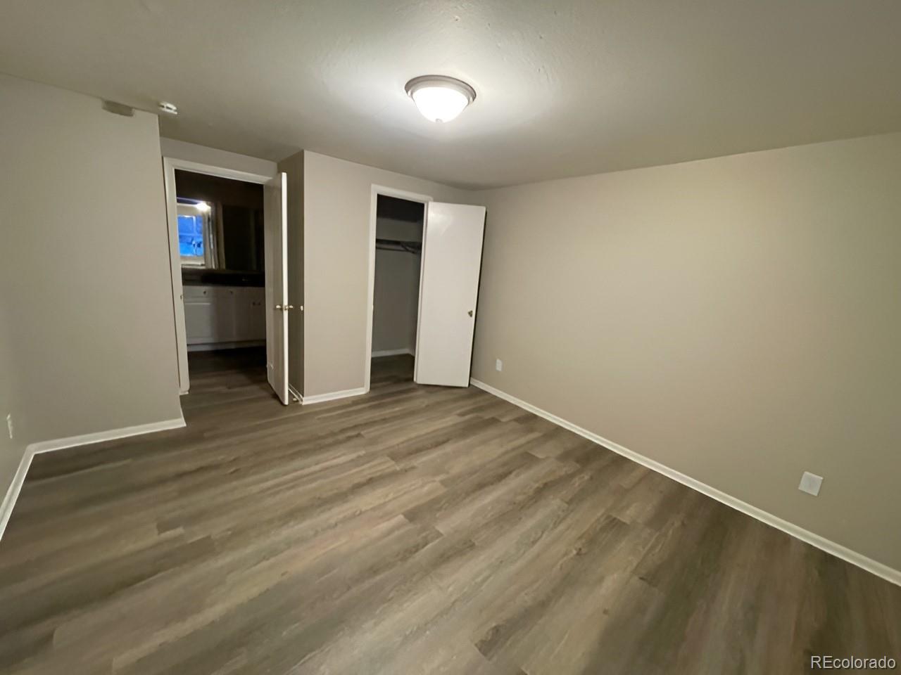 1304 South Parker Road, Unit 148 Denver, CO 80231 - Photo 13 of 23 an empty room with wooden floor and natural light