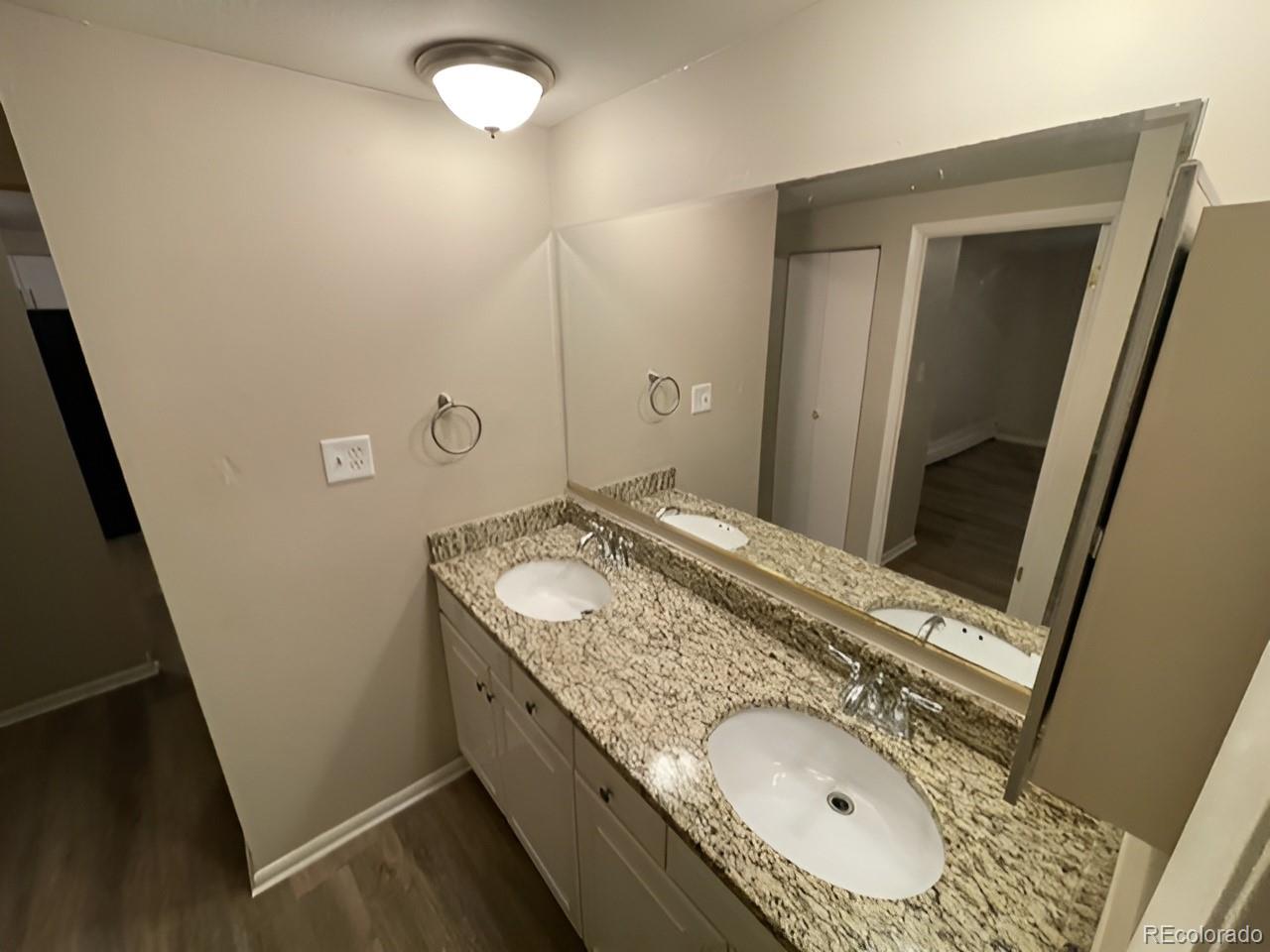 1304 South Parker Road, Unit 148 Denver, CO 80231 - Photo 15 of 23 a bathroom with a granite countertop sink and mirror