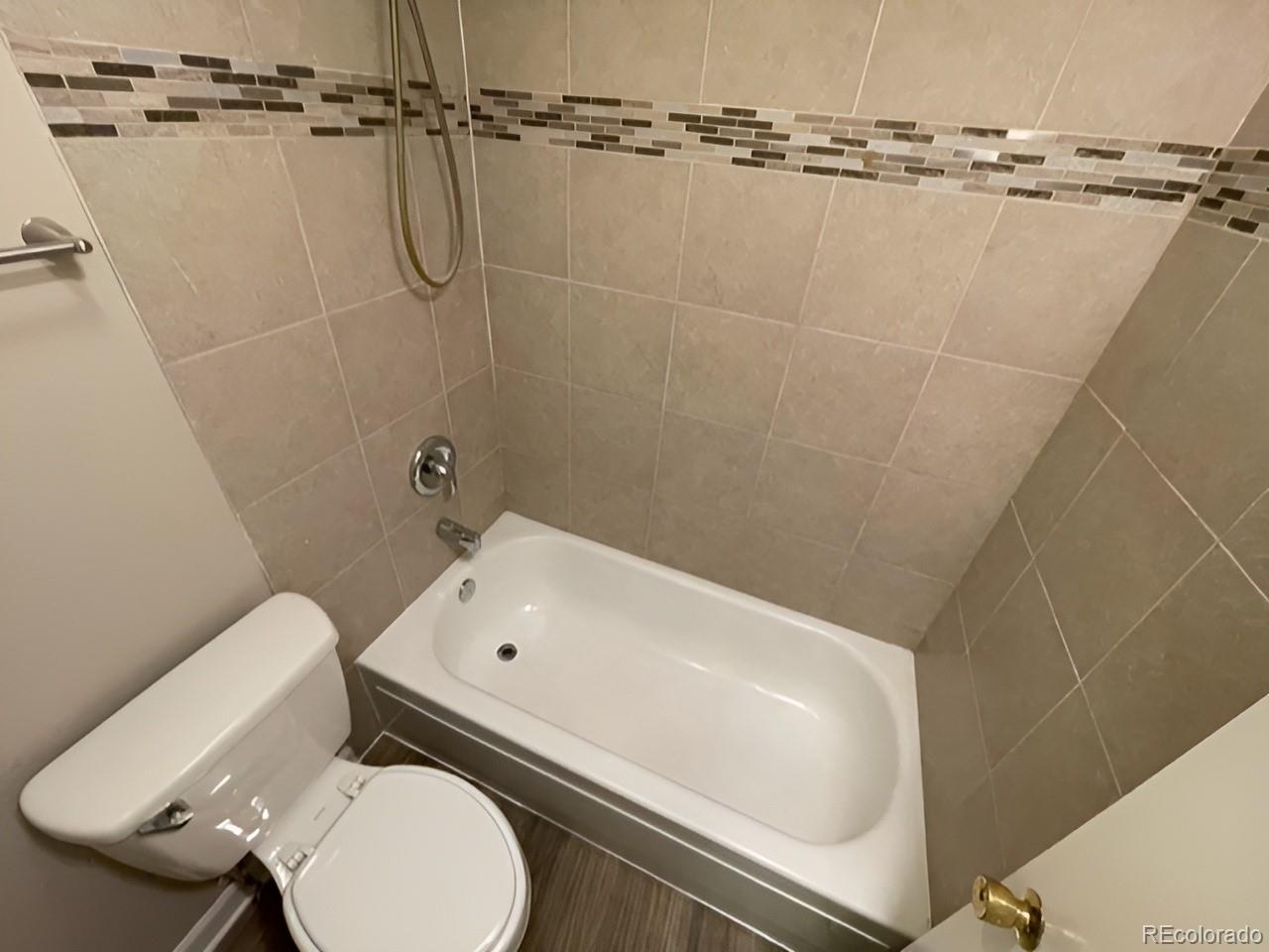 1304 South Parker Road, Unit 148 Denver, CO 80231 - Photo 16 of 23 a bathroom with a sink toilet and shower