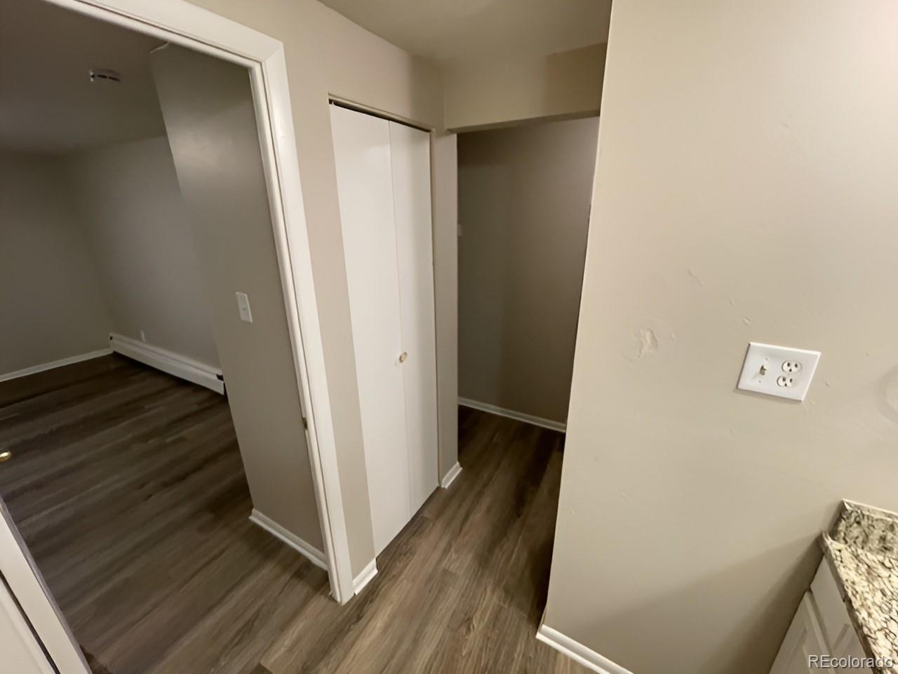 1304 South Parker Road, Unit 148 Denver, CO 80231 - Photo 17 of 23 a view of a hallway with wooden floor