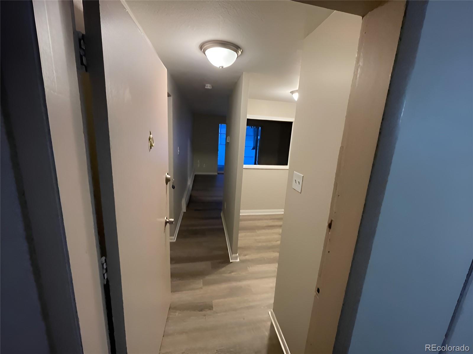 1304 South Parker Road, Unit 148 Denver, CO 80231 - Photo 4 of 23 a view of hallway with stairs and a wooden floor