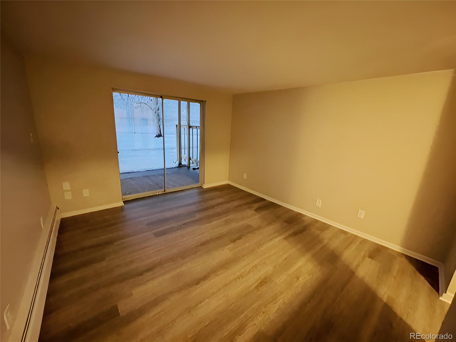 1304 South Parker Road, Unit 148 Denver, CO 80231 - Photo 7 of 23 a view of an empty room and wooden floor