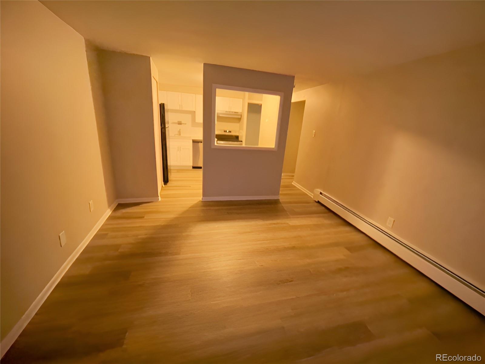 1304 South Parker Road, Unit 148 Denver, CO 80231 - Photo 9 of 23 an empty room with wooden door and windows