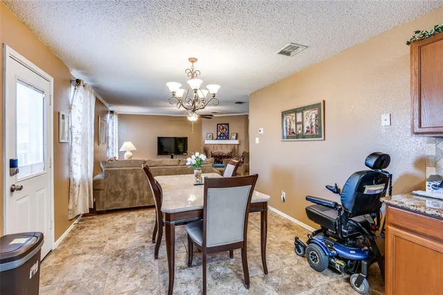 a view of a dining room with furniture and chandelier