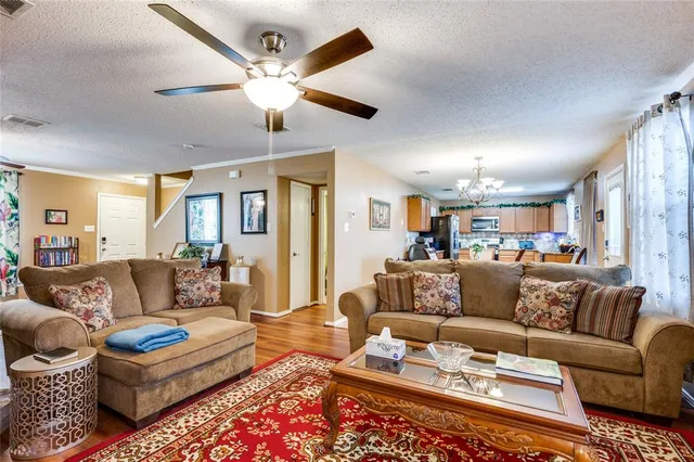 a living room with furniture ceiling fan and a rug