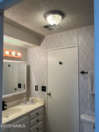 a bathroom with a mirror and a shower