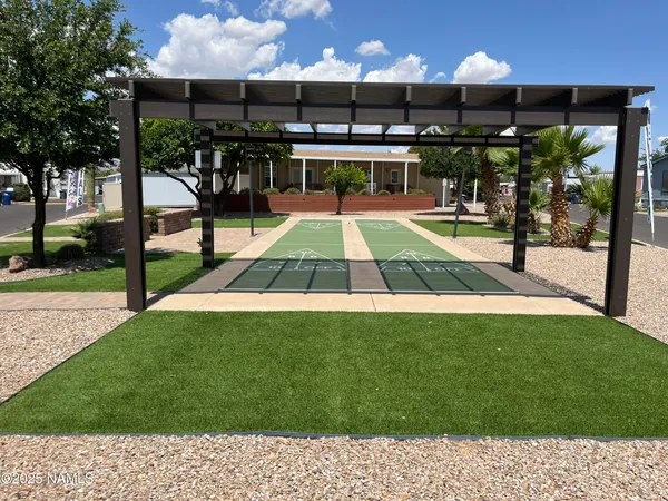 a view of a swimming pool with a patio and a yard