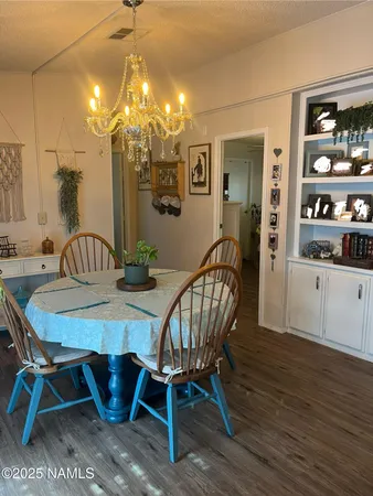 a view of a dining room with furniture and chandelier
