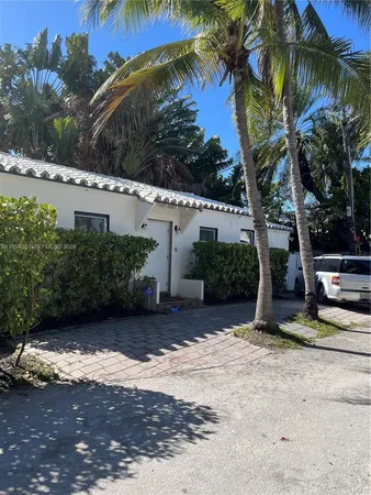 a view of a backyard with plants and a barbeque