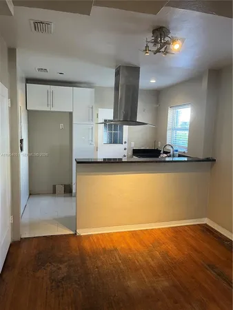 a view of a kitchen with a sink and a stove