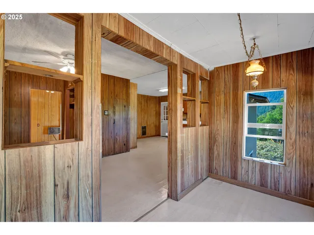a view of a hallway with wooden shelves