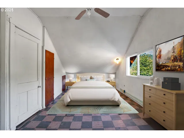 a bedroom with a bed and a flat tv screen on dresser