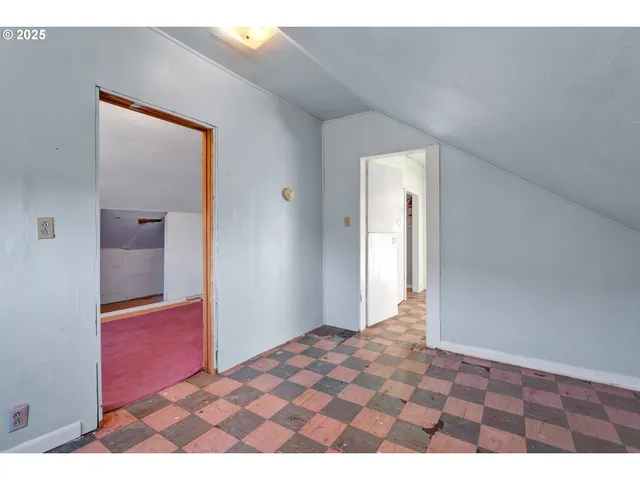 a bedroom with a bed and a lamp