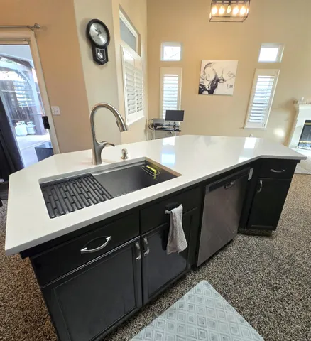 a kitchen with a sink a stove and cabinets