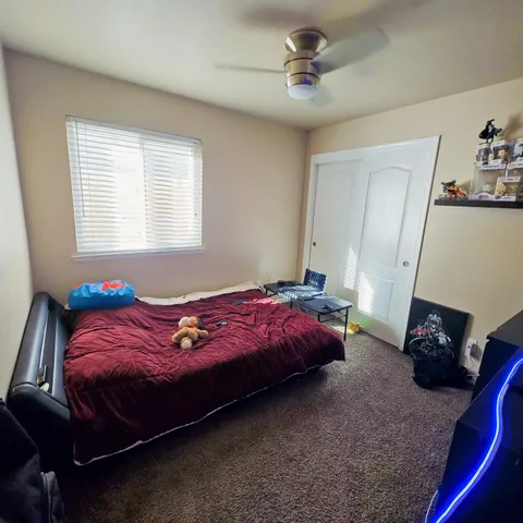 a bedroom with a bed and a window