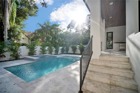 a spacious bathroom with a large mirror vanity and a bathtub