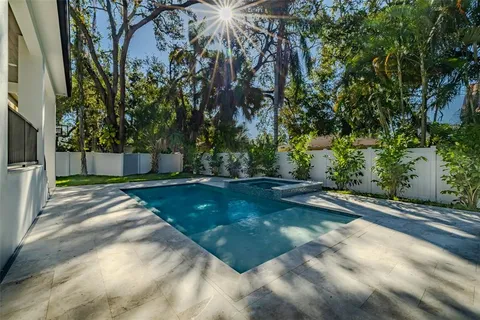 a large bathroom with a large tub shower and sink