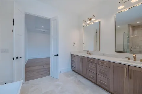 a view of a kitchen with stainless steel appliances granite countertop a stove and a sink