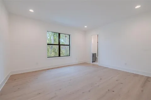 a front view of a house with a garden and plants