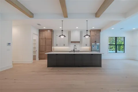 a view of backyard with large windows and plants