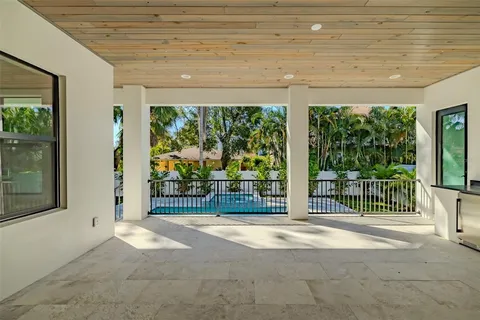 a view of a big room with wooden floor and windows