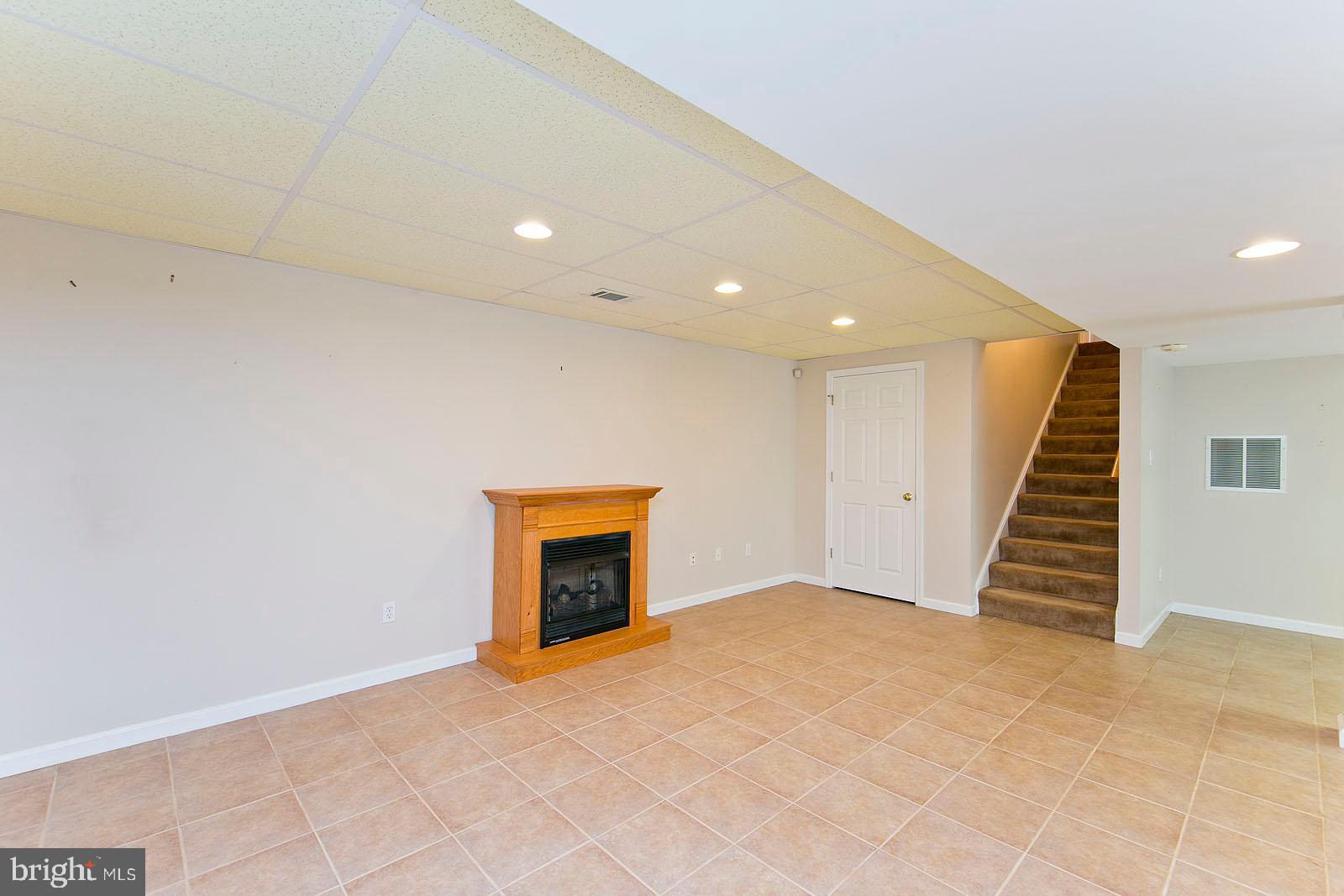 106 Forest Ridge Road Winchester, VA 22602 - Photo 19 of 37 Gas fireplace in the basement & tile floors